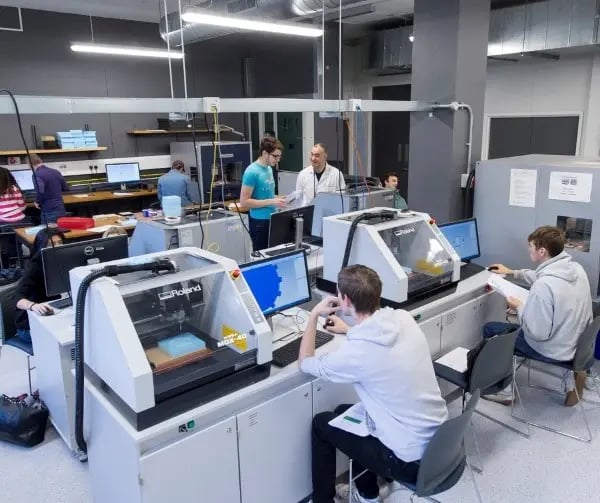 Studierende in einem modernen Labor der University of Sussex arbeiten an technologischen Geräten